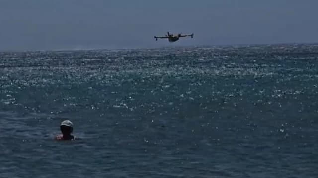 Canadair пополняет запасы воды в заливе Анависсос на глазах у отдыхающих - Видео
